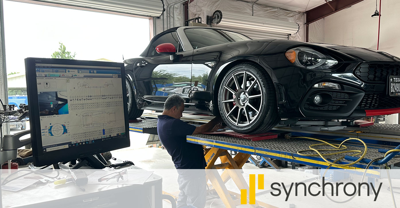 Technician performing a computerized frame measurement on a black sports car at Chapa Autocraft in Kyle, TX — Synchrony financing available for repairs