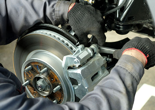 Brake rotor and caliper service being performed at Chapa Auto Craft in Kyle, TX